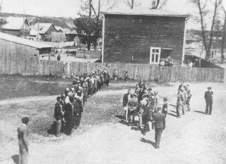 Employees of the Jewish council in the Kovno ghetto assemble during roll call, which was taken on a daily basis. Kovno, Lithuania, between 1941 and 1943